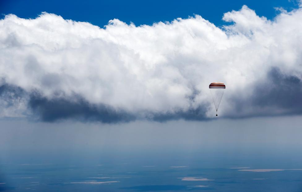 Soyuz TMA-19M spacecraft capsule carrying ISS crew members Peake of Britain, Malenchenko of Russia and Kopra of U.S. descends beneath parachute near Dzhezkazgan